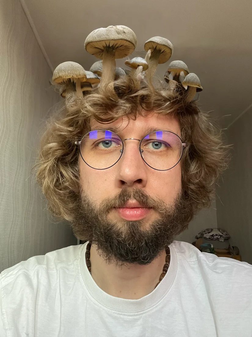 Volodymyr Riabchuk in a playful portrait with mushrooms